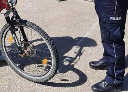 Na zdjęciu widać nogi policjanta który kontroluje rowerzystę.