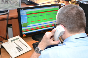 Na zdjęciu policjant rozmawiający przez telefon.