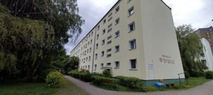 Ma zdjęciu budynek - blok 4 piętrowy