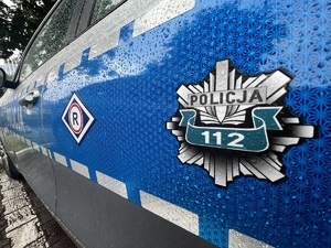 Na zdjęciu drzwi policyjnego radiowozu z logiem - gwiazdą policji