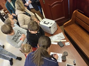 Policjantka umundurowana pokazuje dzieciom zbieranie odcisków palców