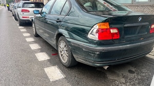 Na zdjęciu widzimy uszkodzone BMW stojące na ulicy Dubois