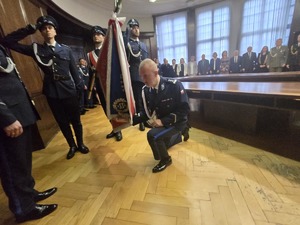 Przy sztandarze klęka dotychczasowy Komendant Miejski Policji w Gliwicach.