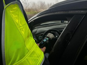 Na zdjęciu ręka umundurowanego policjanta trzymającego urządzenie do nadania stanu trzeźwości