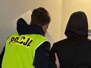 Policjant prowadzi zatrzymanego